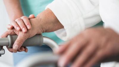 Elderly person with healthcare worker