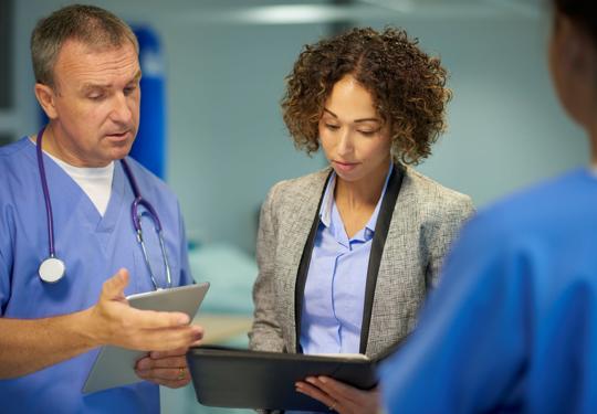 Doctors looking at notes
